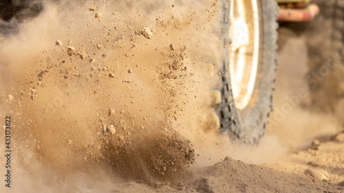 Motion the wheels tires off road dust cloud in desert, Offroad vehicle bashing through sand in the desert. © Kalyakan