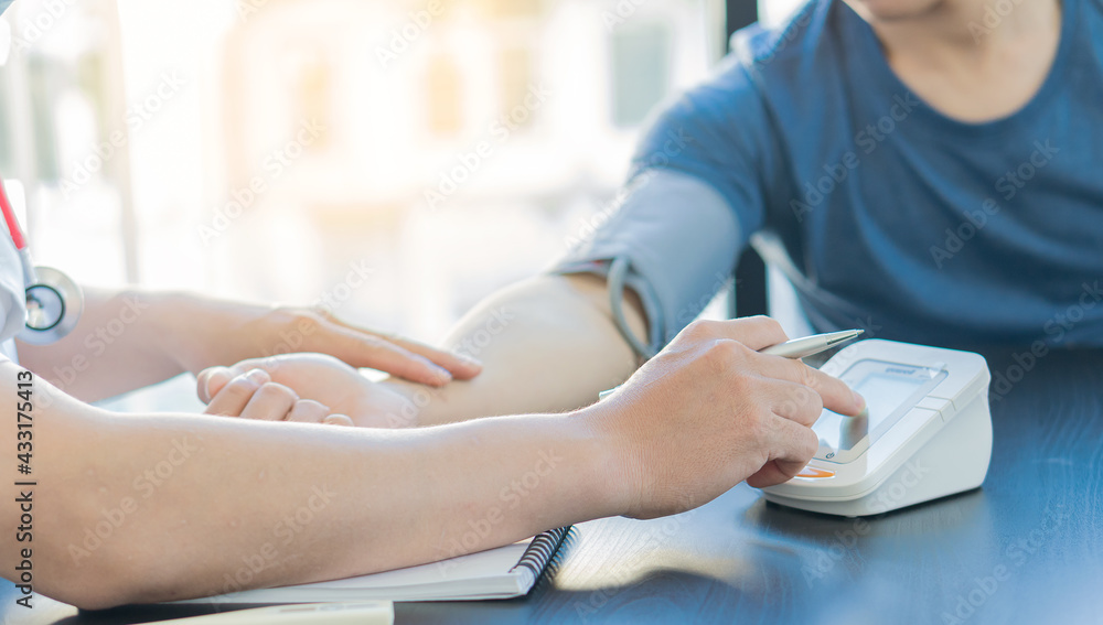 Doctors measure the patient's blood pressure young men diagnosis, prophylaxis of men's health care medical services consultation Doctors measure the patient's blood pressure young men diagnosis, prophylaxis of men's health care medical services consultation