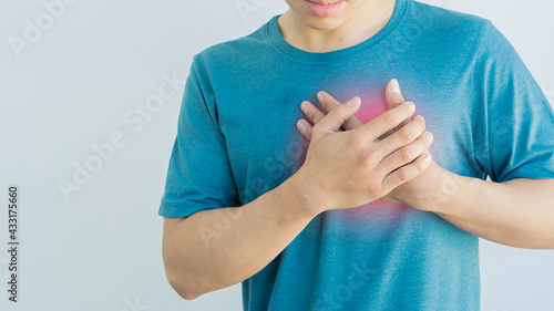 A man holding the chest With pain in his chest The sore spot is highlighted in red.