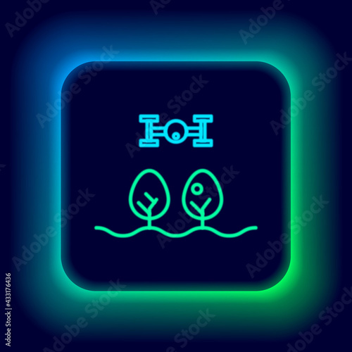Glowing neon line Smart farm with drone control and tree icon isolated on black background. Innovation technology for agricultural company. Colorful outline concept. Vector