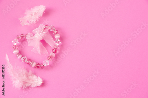 Creative layout with pink heart of cristal beads, paper pink background. Top view, flat lay. Concept for wedding, mother's day, women's day, 8 march, empty space