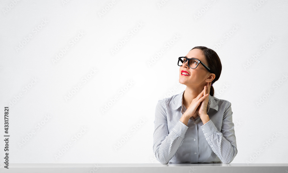 Confident businesswoman in glasses sitting at desk Confident businesswoman in glasses sitting at desk