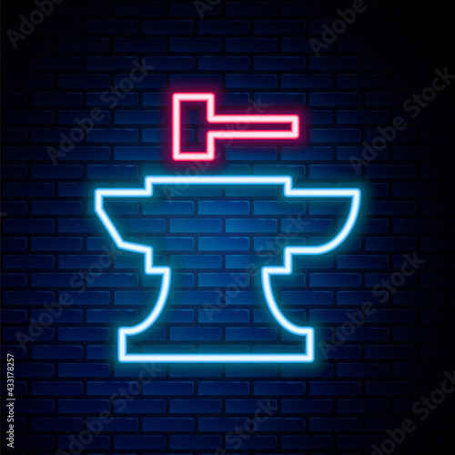 Glowing neon line Anvil for blacksmithing and hammer icon isolated on brick wall background. Metal forging. Forge tool. Colorful outline concept. Vector