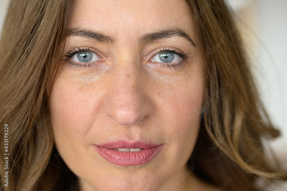 Cropped view of the face of an attractive middle-aged woman Cropped view of the face of an attractive middle-aged woman
