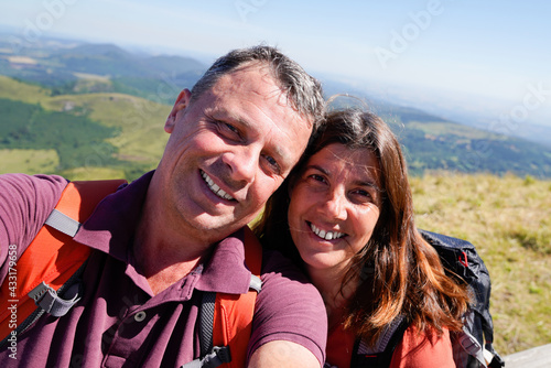 Loving cheerful happy couple taking selfie in mountain vacation