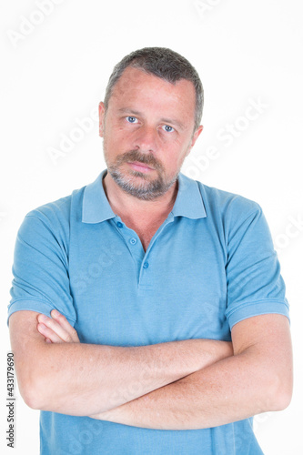 Handsome serious face man portrait arms crossed aside copy space in white background