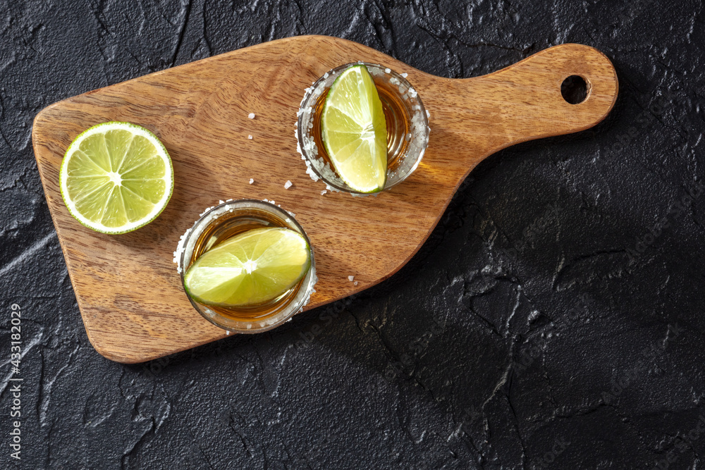 Tequila with salt and lime, shot from above with a place for text - obrazy, fototapety, plakaty 