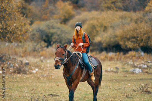 woman hiker rides a horse in a field mountains nature landscape © SHOTPRIME STUDIO