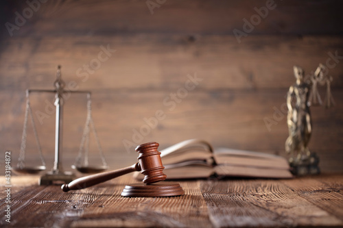 Law theme. Lawyers office. Gavel on the rustic brown desk. 