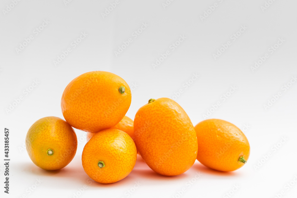 kumquat on white background. exotic fruits kumquat on white background. exotic fruits