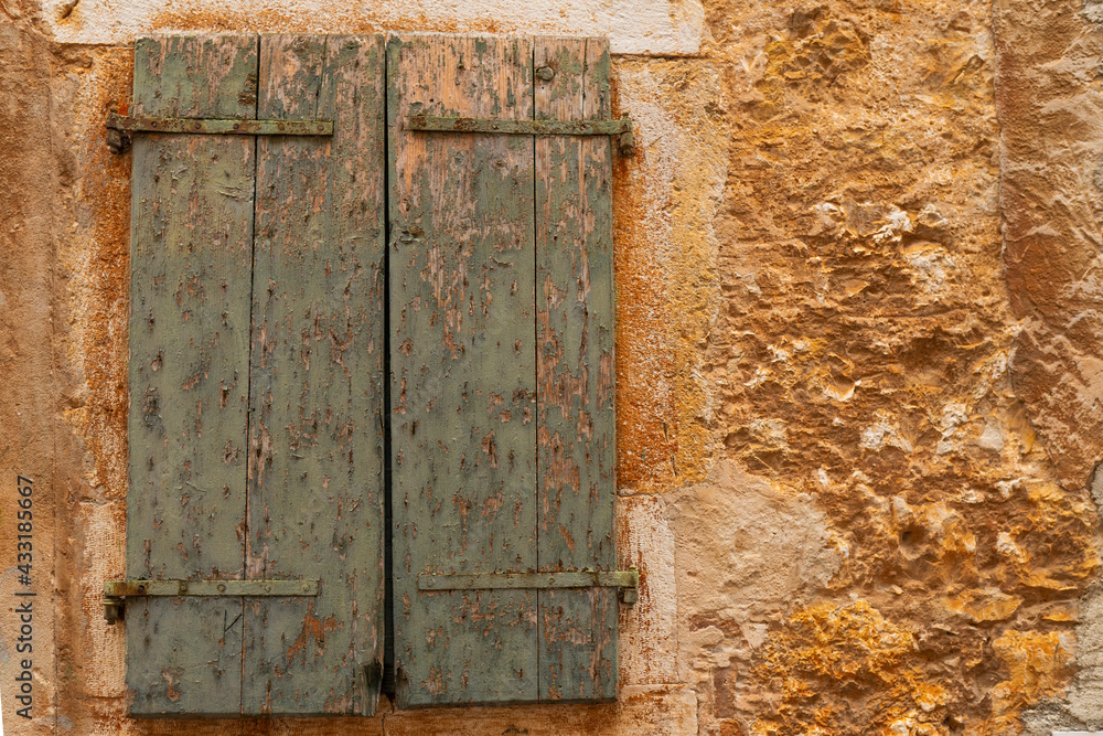 Facade window of an old European Mediterranean town. Close-up. Texture. Facade window of an old European Mediterranean town. Close-up. Texture.