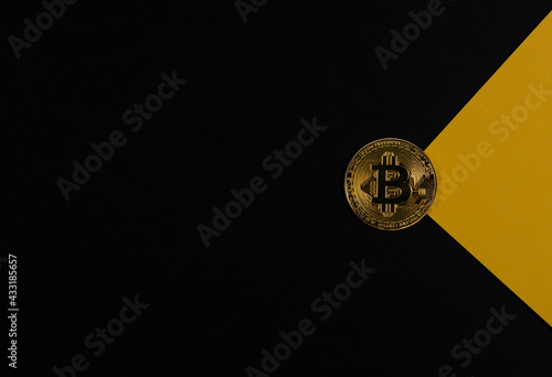 Bitcoin golden coin on black banner with copy space for text and yellow light ray or beam. Cryptocurrency and crypto investment photo