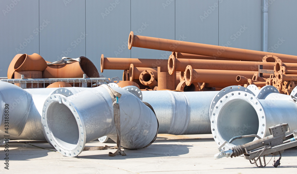 Large steel pipes on the ground, focus on the rusted pipes Large steel pipes on the ground, focus on the rusted pipes