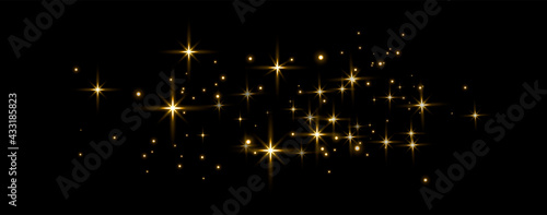 Gold glittering dots, sparkles, particles and stars on a black background. Abstract light effect. Gold luminous points. Vector illustration.