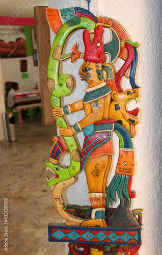 Mexican souvenirs:  wooden statue of Indian man (Native American man) in the souvenir shop in Chichen Itza, Riviera Maya, Quintana Roo, Mexico.