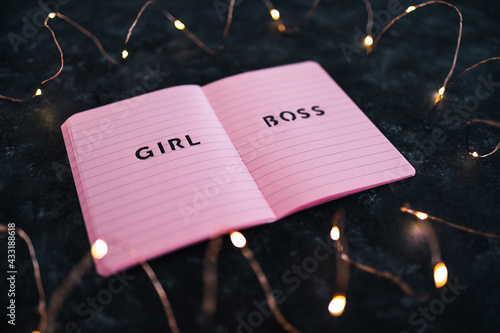 girl boss notepad surrounded by fairy lights, supporting equality and business growth