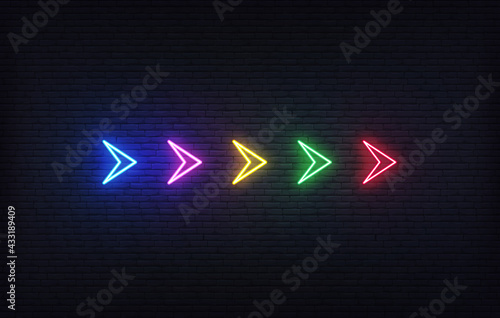 Neon futuristic arrow sign. Set of colorful glowing neon arrow pointer on brick wall background