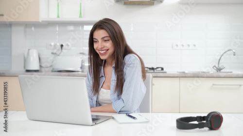 Front view portrait of smiling attractive young woman communication on webcam online at home with good mood. Concept of process working or studying online at home during quarantine. 