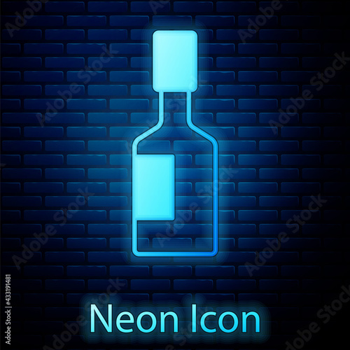 Glowing neon Tabasco sauce icon isolated on brick wall background. Chili cayenne spicy pepper sauce. Vector