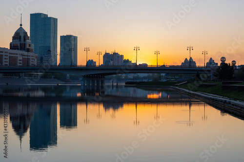 The first rays of sunlight over the bridge Sary-Arka and Ishim River in Nur-Sultan, Kazakhstan.