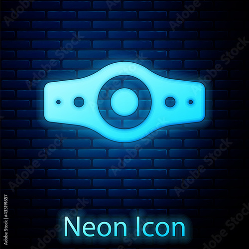 Glowing neon Wrestling championship belt icon isolated on brick wall background. Vector