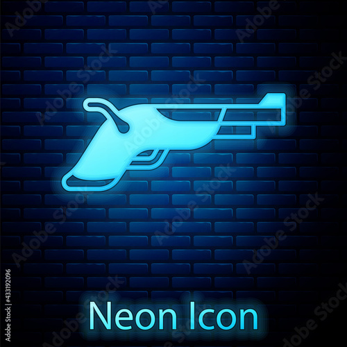 Glowing neon Vintage pistols icon isolated on brick wall background. Ancient weapon. Vector