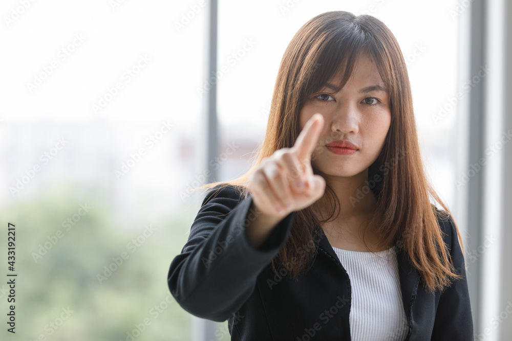 Business full length in black suit. Asian businesswoman holding pointing his finger forward to working intelligent monitor. Beautiful and confident working woman. Business full length in black suit. Asian businesswoman holding pointing his finger forward to working intelligent monitor. Beautiful and confident working woman.