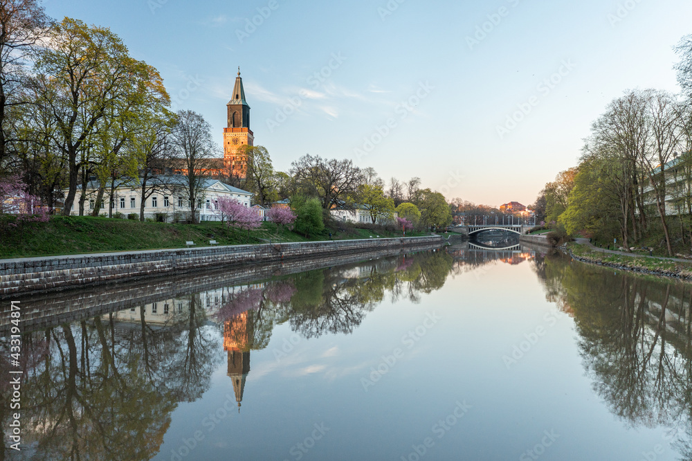 Calm Aura river and the cathedral in Turku, Finland in spring morning.