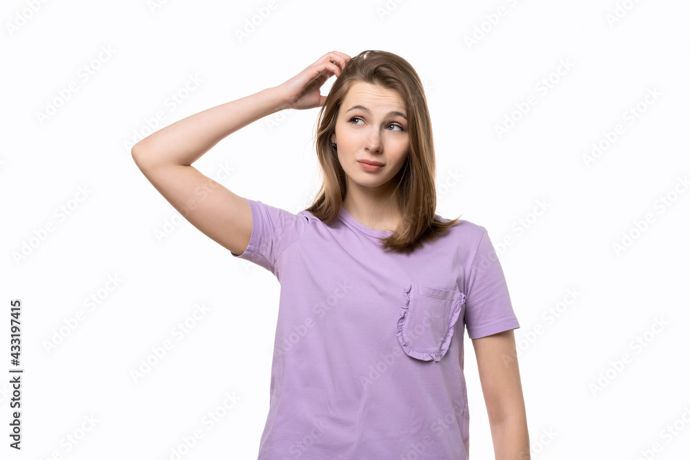 young pretty woman thinking and wonder. Studio shot, white background young pretty woman thinking and wonder. Studio shot, white background