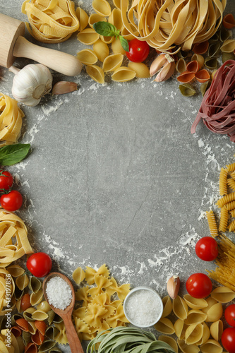 Concept of cooking pasta on gray textured background