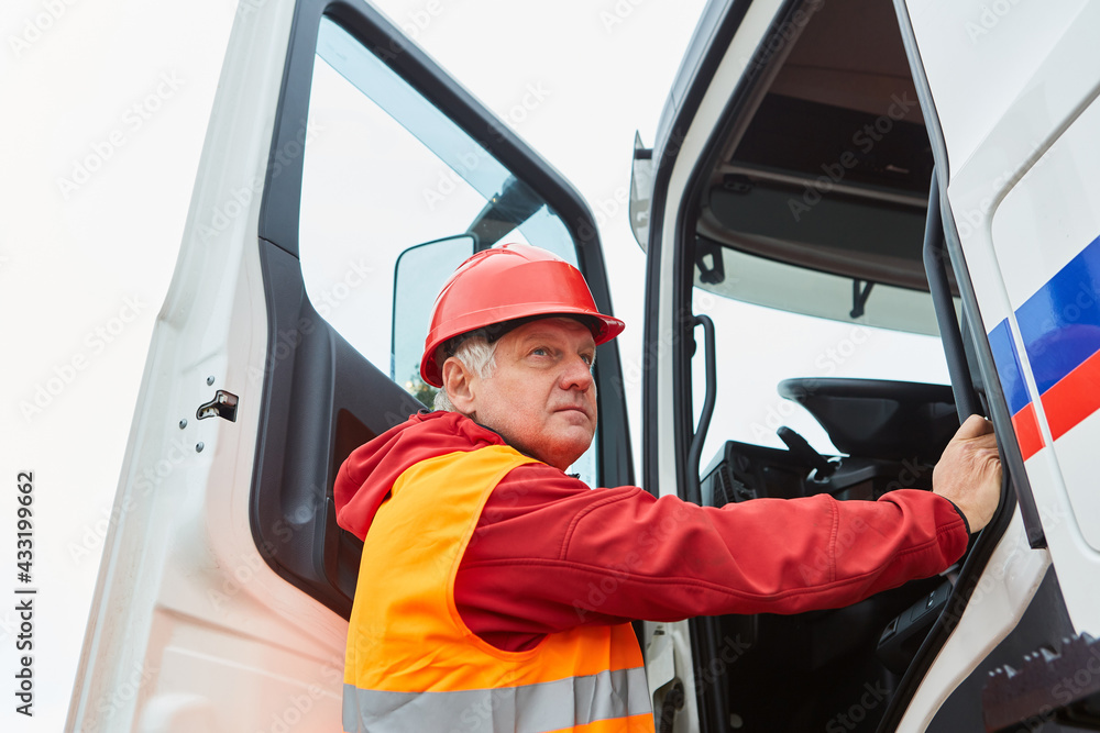 Truck driver in front of the cab on the construction site Truck driver in front of the cab on the construction site