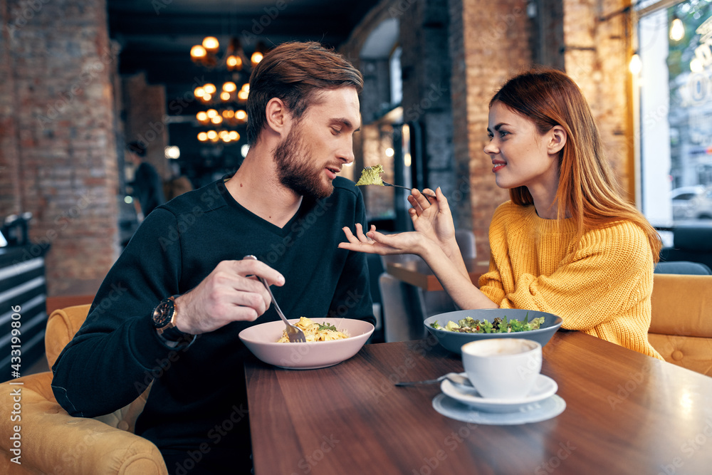 man and woman sitting in a cafe communication snack lifestyle romance
