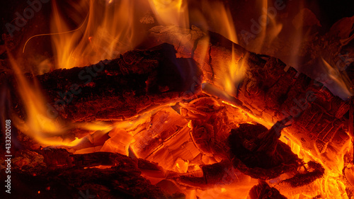 Close up view of the small fire and embers in a campfire or in a fireplace. photo