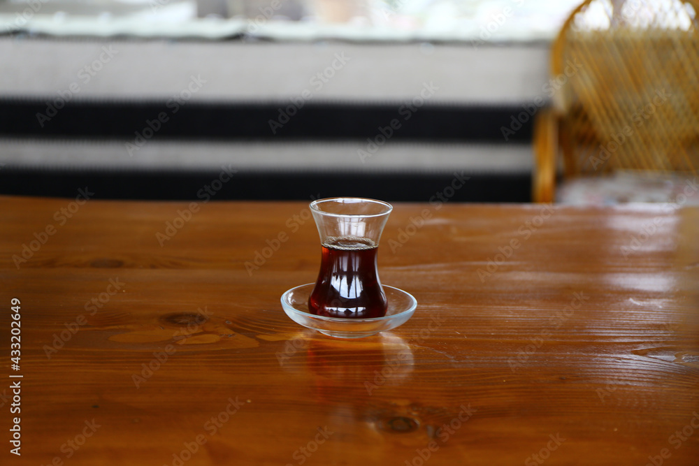 Thin belly, tea cup traditional serving style in Turkey for hot black tea. Black tea serving style. Tea and coffee shop in Istanbul. Thin belly, tea cup traditional serving style in Turkey for hot black tea. Black tea serving style. Tea and coffee shop in Istanbul.