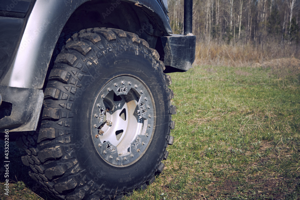 4x4 off-road car wheels on grass. Off-road tire 4x4 off-road car wheels on grass. Off-road tire