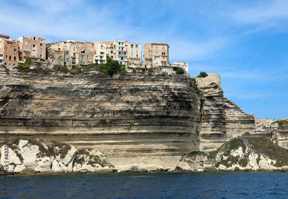 Houses of Bonifacio City on the French island Corsica built over the sheer cliff seen from the Mediterranean Sea