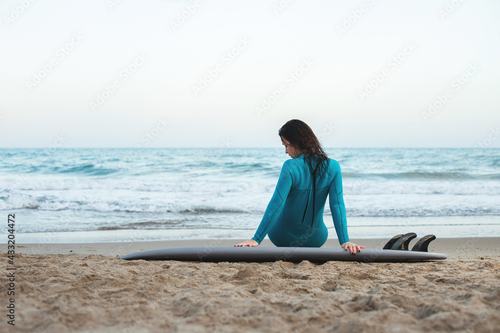 Surfer girl walking with board on the sandy beach. Surfer female.Beautiful young woman at the beach. water sports. Healthy Active Lifestyle. Summer Vacation. Extreme Sport