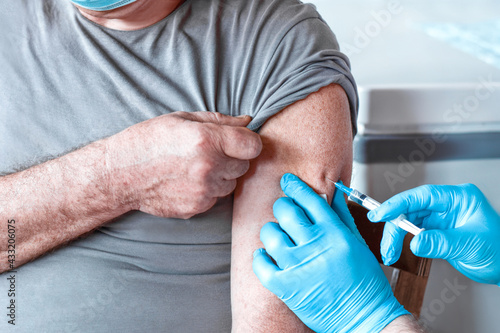 Принти на полотні Elderly Man in Face Mask getting Covid Vaccine