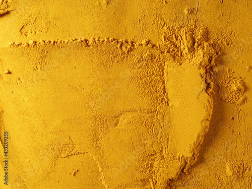 Yellow powder of grated turmeric. View from above.