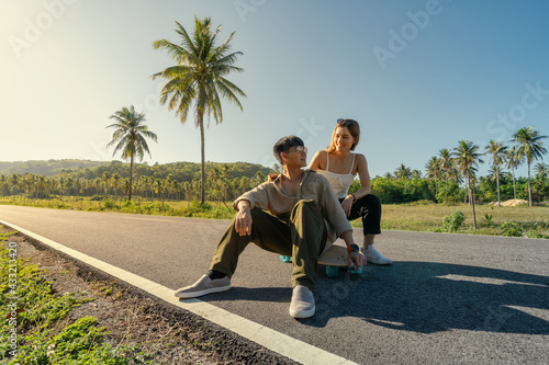 Portrait of Asian Lover Couple with Trendy Sport Equipment SurfSkate