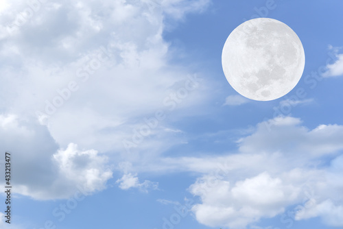 Full moon and white clouds on the sky.