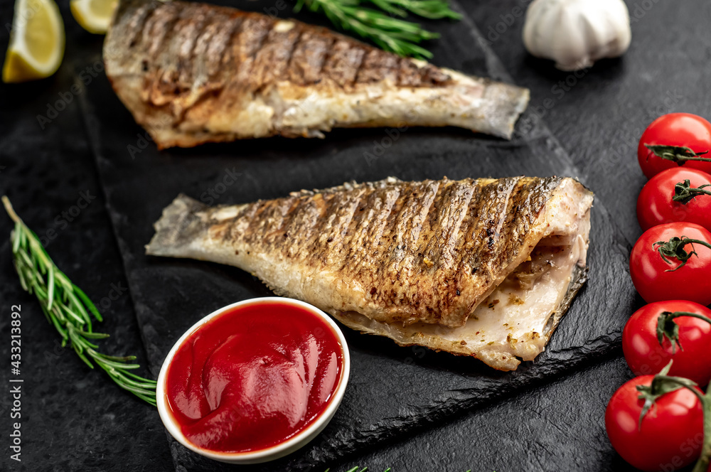 grilled sea bass with spices on a stone background grilled sea bass with spices on a stone background