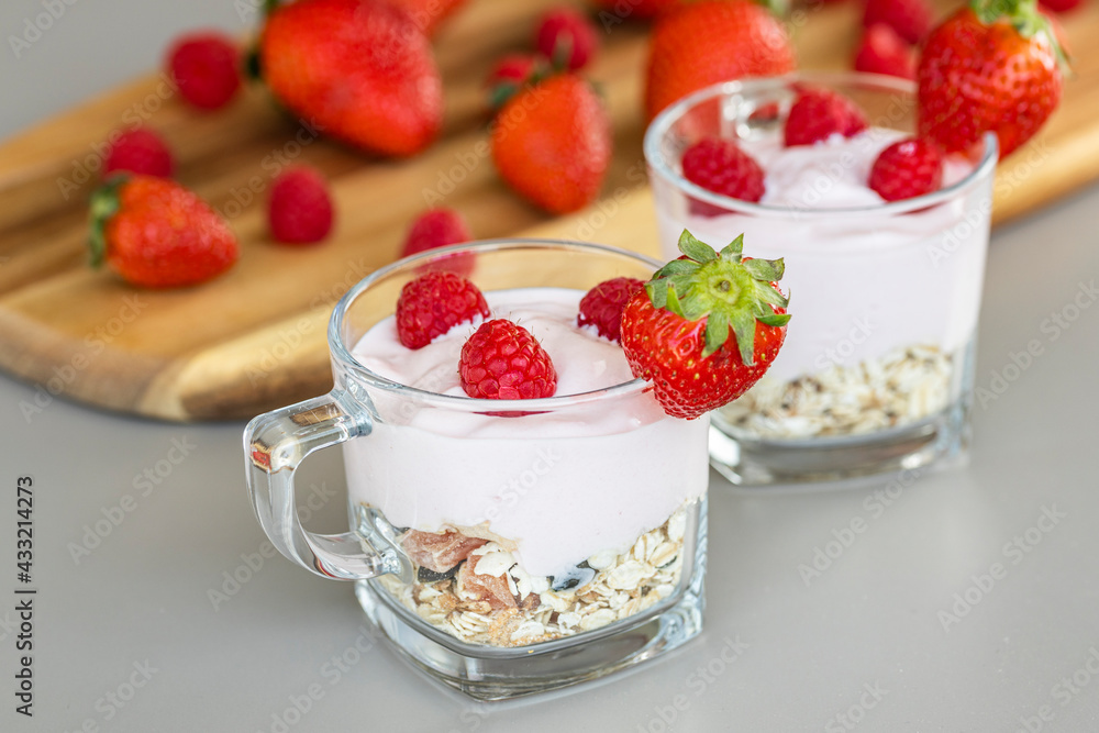 Delicious strawberry and raspberry yogurt with cereals Delicious strawberry and raspberry yogurt with cereals