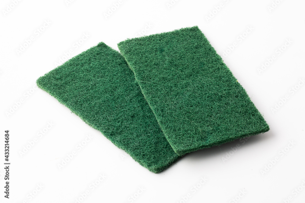 Green scouring pad isolated on a white background, square shape, Dishwashing tools for scrubbing, cleaning tools, Housework. Green scouring pad isolated on a white background, square shape, Dishwashing tools for scrubbing, cleaning tools, Housework.