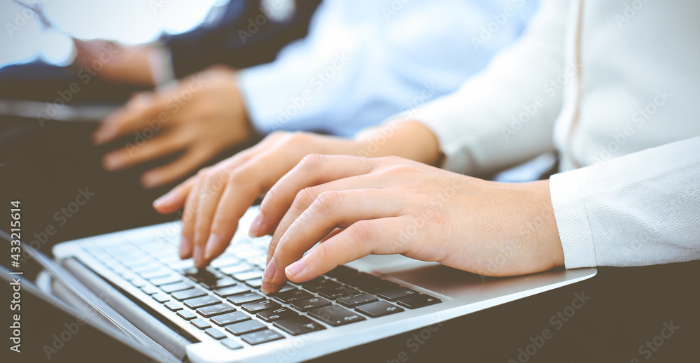 Group of business people working in office, close-up. Businesswoman working with laptop. Conference or training concepts Group of business people working in office, close-up. Businesswoman working with laptop. Conference or training concepts