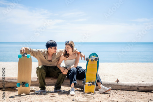 Portrait of Asian Lover Couple, With trendy Sport Equipment Surfskate