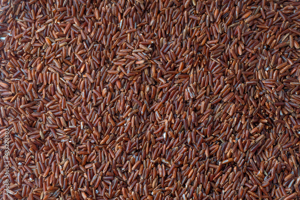 Red rice (brown rice) on flat lay, Whole grain rice with lots of fiber and benefits, unpolished rice, background, texture.