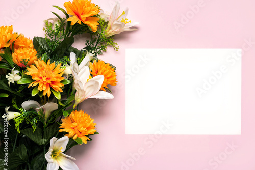 Happy Mother's Day.Bouquet of yellow flowers and white paper with copy space background