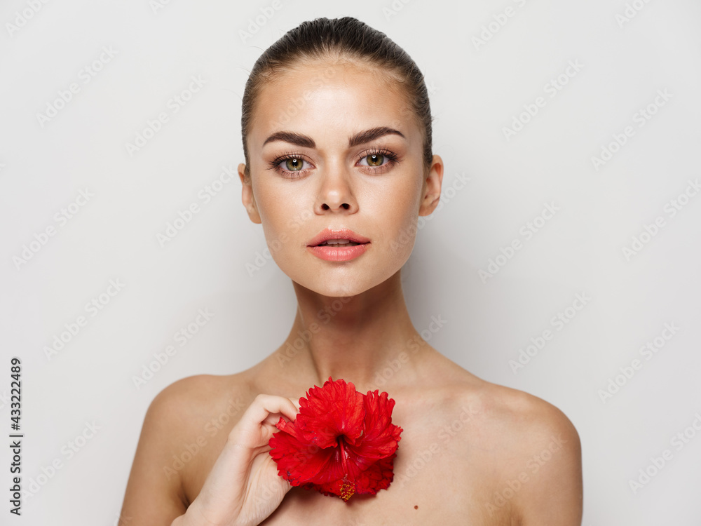 pretty woman naked shoulders red flower attractive look close-up pretty woman naked shoulders red flower attractive look close-up
