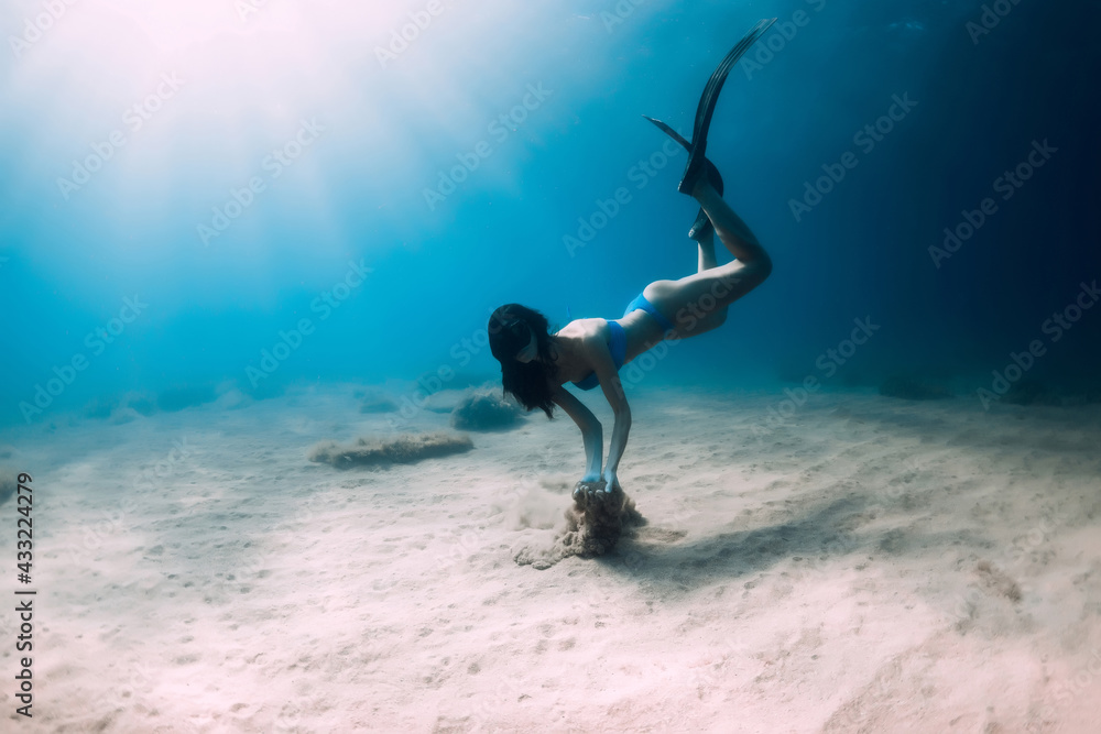 Female freediver underwater. Freediving in transparent sea